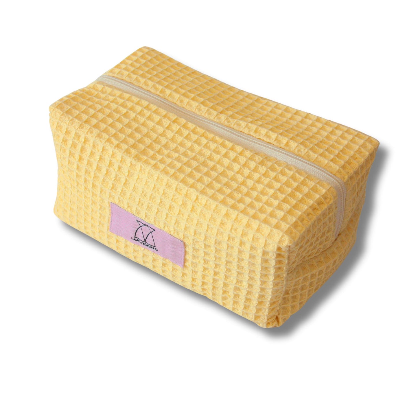 Beautybag/Kosmetiktaschein warmem Buttergelb aus Waffelpique-Stoff, leicht texturiert, kompakt